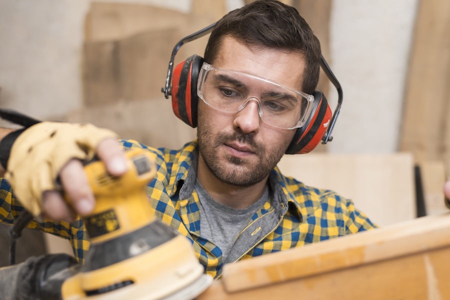 worksafe carpenter polishing wooden board